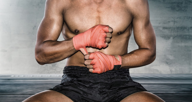close-up-hand-boxer-pulls-wrist-wraps-before-training_104033-112