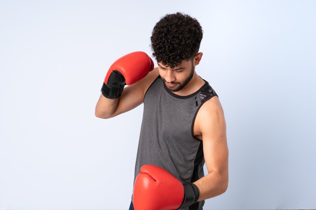 young-moroccan-man-isolated-blue-with-boxing-gloves_1368-151906